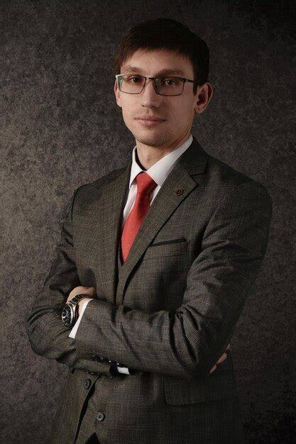 Premium Photo A Man In A Suit And Glasses Stands With His Arms Crossed