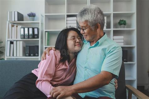 A Father And Daughter Sat In The Living Room Happily Spending Time