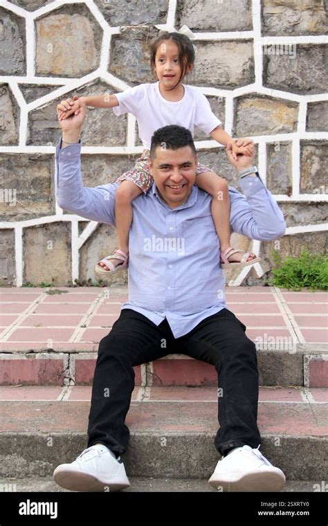 Divorced Single Dad Carries His Year Old Latina Daughter On His Shoulders In Piggyback Style