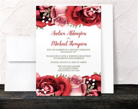 a wedding card with red roses on it