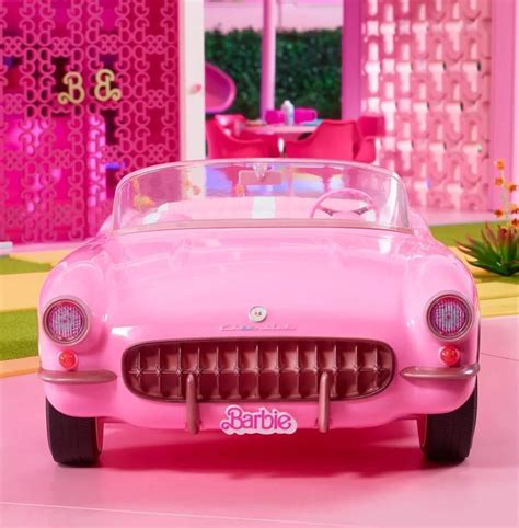 barbie's pink car is parked in the living room