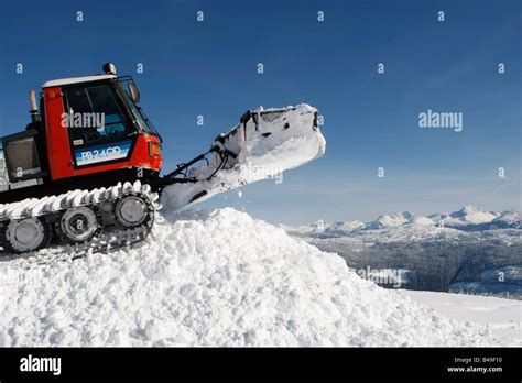 snow cat ploughing snow to build a snowboard jump Stock Photo - Alamy