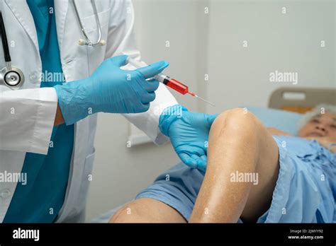 Asian Doctor Inject Hyaluronic Acid Platelet Rich Plasma Into The Knee