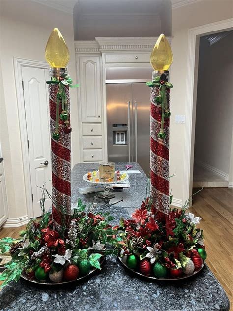 Two Christmas Decorations On Plates In The Middle Of A Kitchen