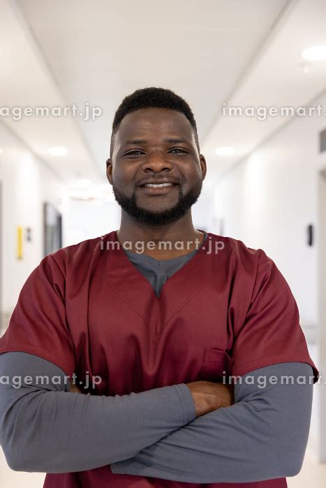 Portrait Of Happy African American Male Doctor In Hospital Corridor