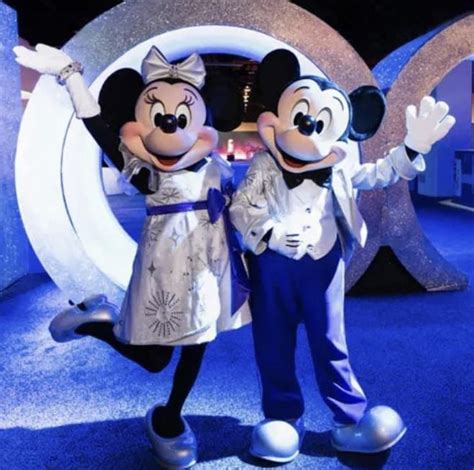 Two Mickey And Minnie Mouse Characters Posing For The Camera