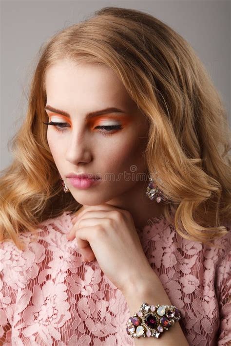 Beauty Studio Portrait Of Girl In Pink Dress With Wavy Hairstyle Stock