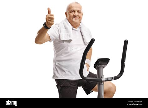 Mature Man On An Exercise Bike Showing Thumbs Up Isolated On White Background Stock Photo Alamy