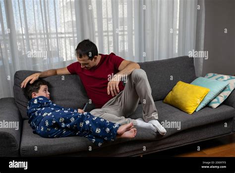 Mature Man 44 Years Old Sitting Next To His Son 6 Years Old And Stroking His Head Stock