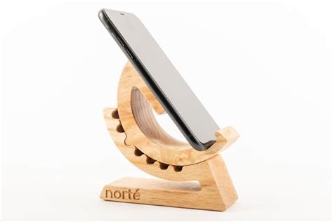 A Wooden Stand With A Cell Phone On It S Back And The Word Note Written