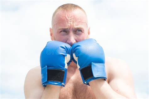 Fighter Man Boxer Or Athlete With Naked Muscle Torso Posing In Red Punching Gloves In Boxing