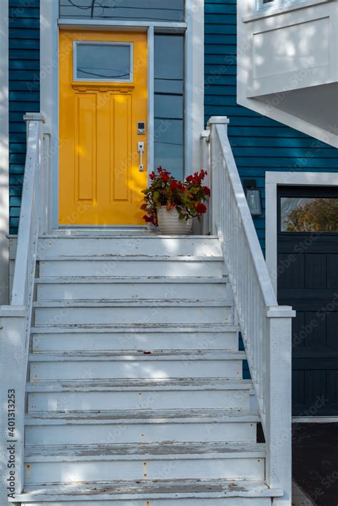 White Painted Steps Leading Up To A Bright Yellow Door With A Small