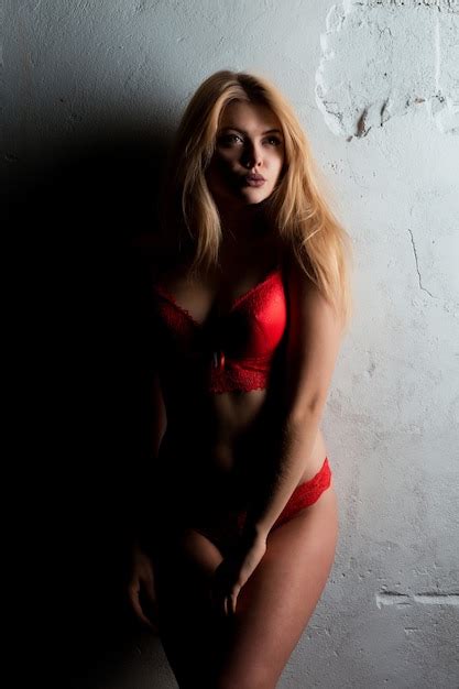 Premium Photo Sexy Blonde Model With Long Hair In Red Lace Lingerie Posing In The Dark Room