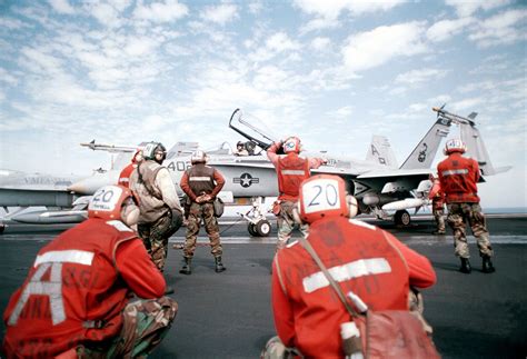 Us Navy And Marine Corps Flight Deck Crewmen Prepare An F A C Hornet