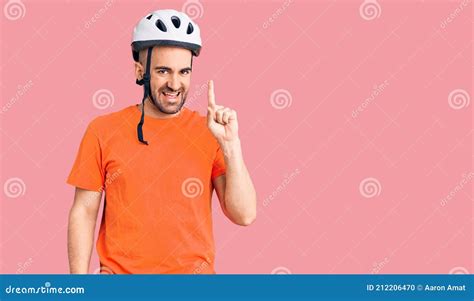 Young Handsome Man Wearing Bike Helmet Pointing Finger Up With