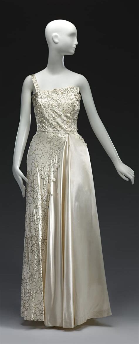 A White Mannequin Wearing A Gold Dress