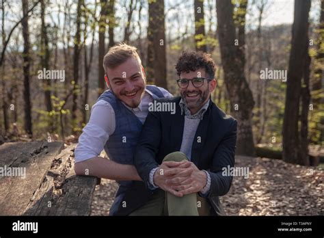 Two Men Happy Gay Couple Sitting On A Bench In Forest Leisure Time Outdoors Stock Photo Alamy