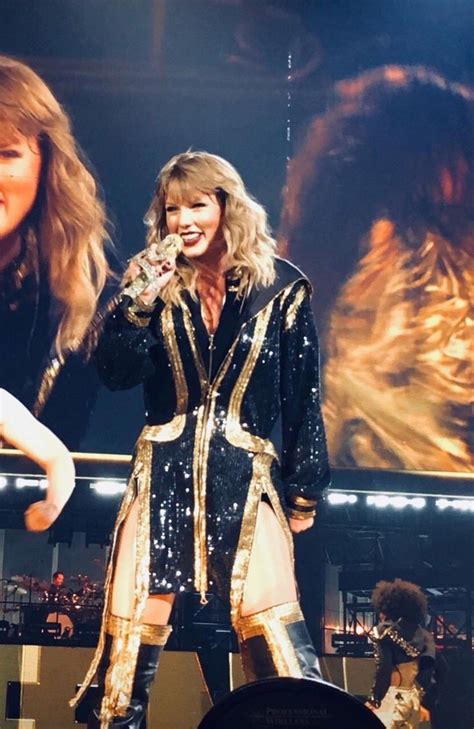 Taylor Swift Performing On Stage At A Concert With Two Women In The