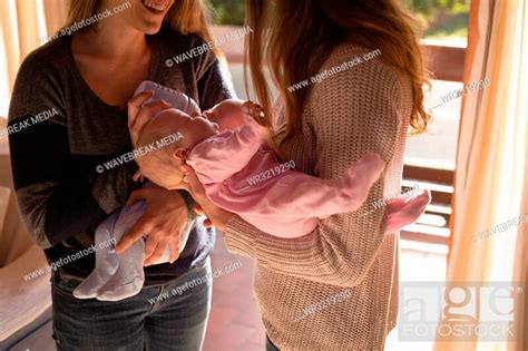 Lesbian Couple Holding Their Babies At Home Stock Photo Picture And Royalty Free Image Pic