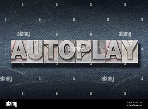 Autoplay Word Made From Metallic Letterpress On Dark Jeans Background