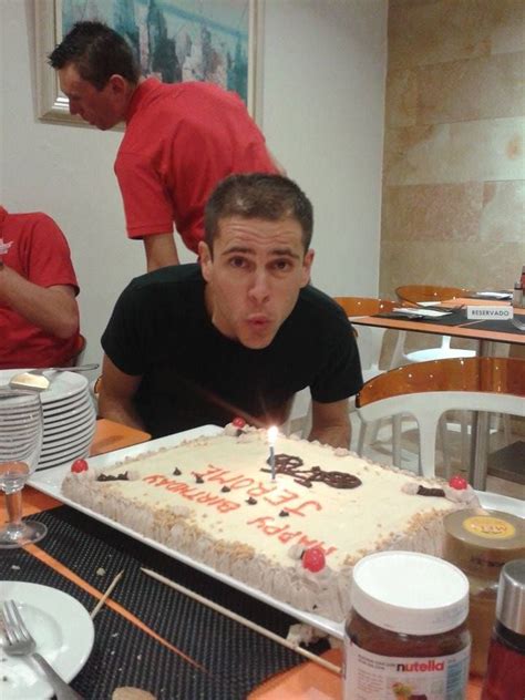 A Man Blowing Out The Candles On His Birthday Cake