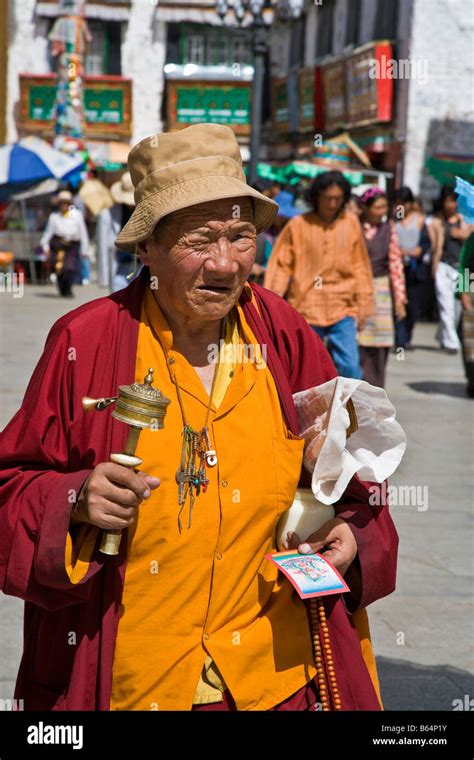 Old Tibetan Man Pilgrim Spinning Prayer Wheel In The Barkhor Lhasa