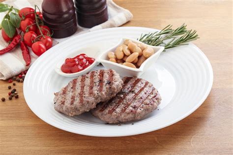 Premium Photo Grilled Beef Burger Cutlet With Sauce And Beans