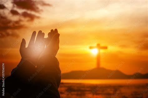 Christian woman praying worship at sunset. Hands folded in prayer ...