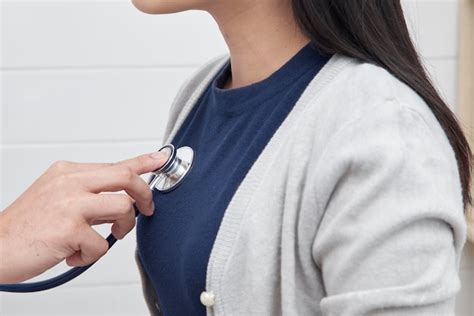 Premium Photo Cropped Hand Of Doctor Examining Woman