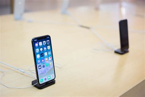 Apple iPhone X on a docking station in an apple store - Creative ...