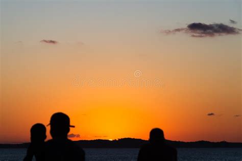 Silhouette At Sunset Of People Walking On The Edge Of Porto Da Barra