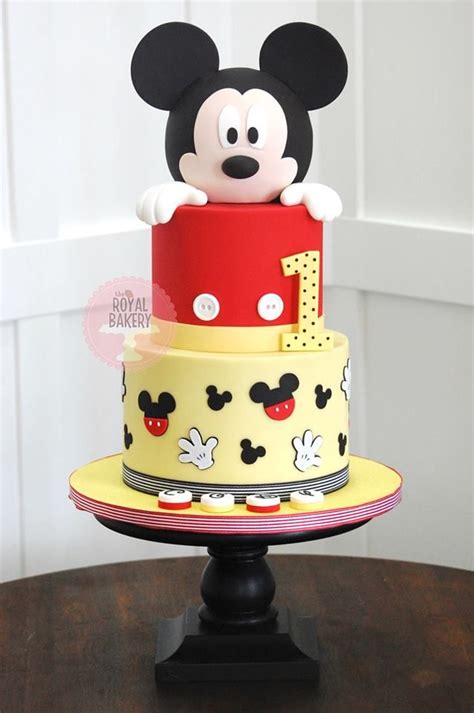 A Mickey Mouse Cake On Top Of A Wooden Table