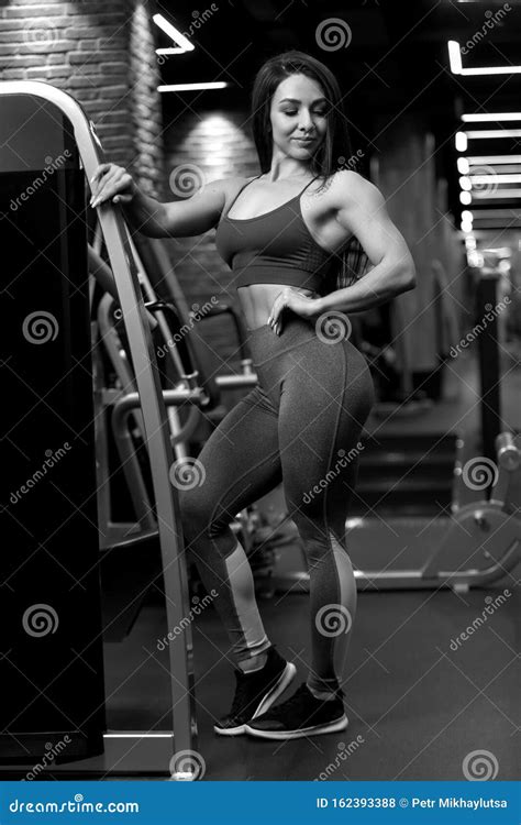Fitness Brunette Girl Is Standing Near Training Apparatus And Posing BW