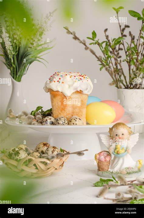 Easter Cake And Colorful Eggs On A Festive Easter Table With Pussy Willow And Angel Figurine