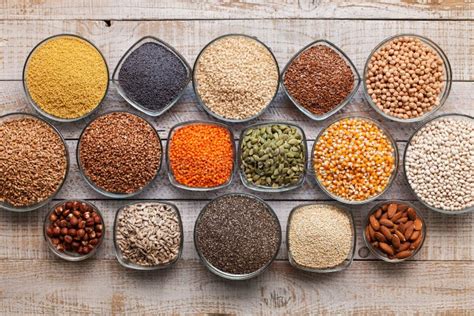 Various Seeds, Grains and Nuts on Old Table - in Bowls, Top View Stock ...