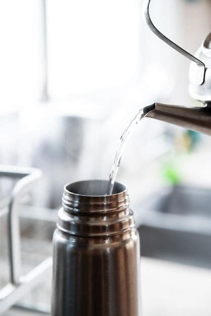 Premium Photo Filling Hot Water Thermos With Stainless Steel Kettle And Thermos