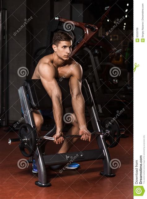 Muscular Man Working Out In Gym Doing Exercises With Barbell Stock Image Image Of Biceps Male