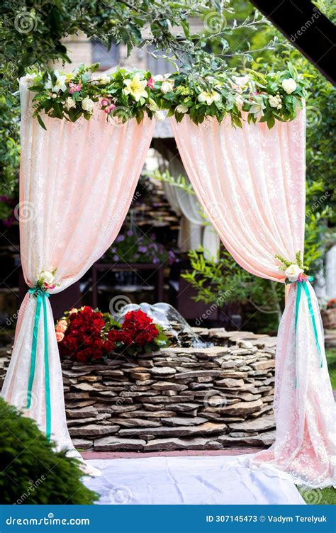 Arch For The Wedding Ceremony Decorated With Cloth And Flowers Stock