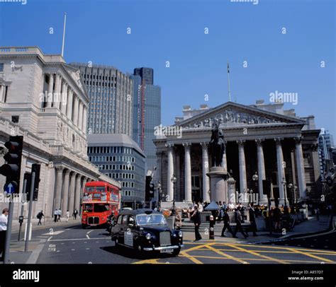 Black London taxi and red London bus in the financial district of the ...