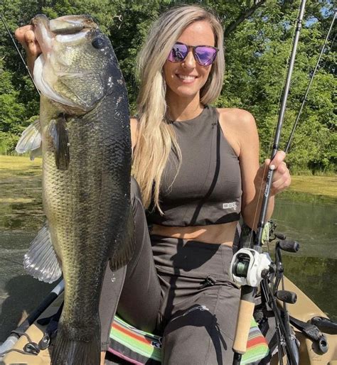 Woman Catching Big Bass In A Boat