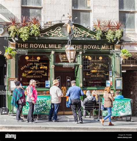 Customers And Potential Customers Outside The Royal Mile Tavern In The