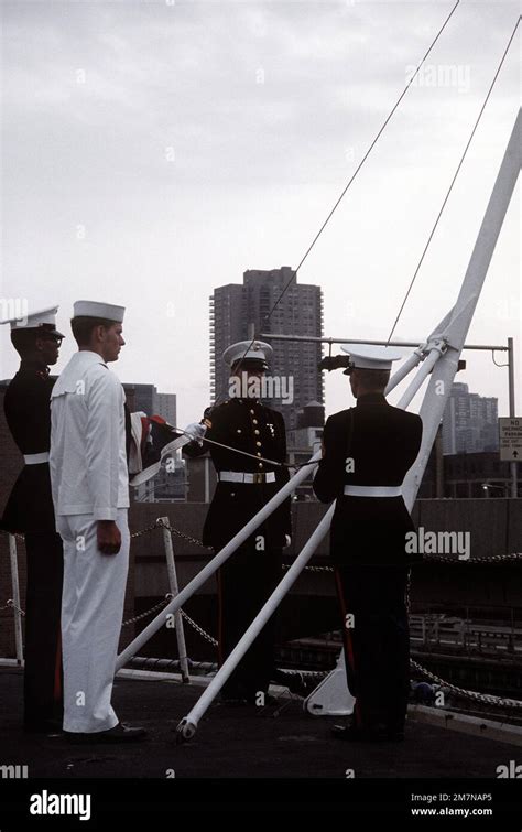 A Navy And Marine Color Guard Raise The Colors Aboard The Amphibious