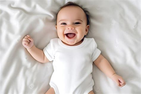 Baby Wearing White Shirt Bodysuit Mockup At White Bed Background Design