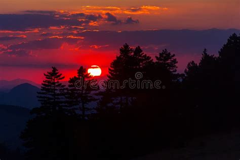 Sunset in a red sky stock image. Image of meadow, hill - 100282441