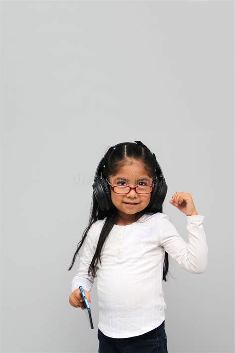 Year Old Brunette Latin Girl With Glasses Listens To Music In Her Headphones Connected To Her