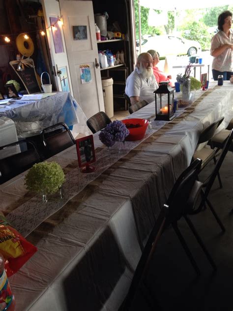 Several People Sitting At A Long Table With Food On It