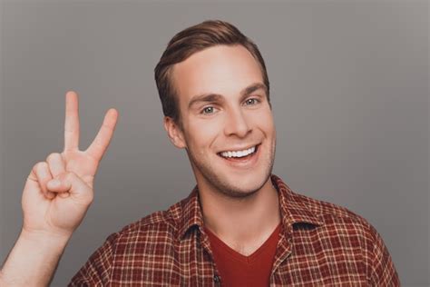 Premium Photo Handsome Cheerful Man Gesturing With Two Fingers