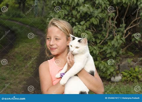 Beautiful Caucasian Girl Holding A White Cat In Her Arms Outdoors In Summer Stock Image Image