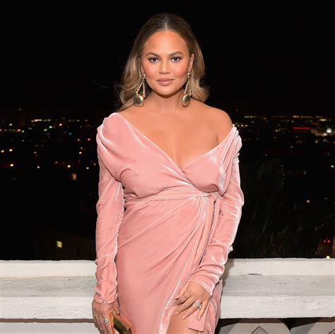 Chrissy Teigen Shows Off Her Pregnancy Glow In A Revealing Pink Dress