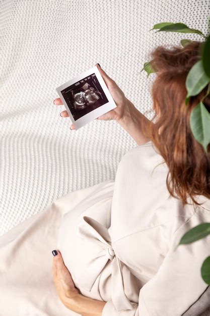 Premium Photo Pregnant Woman Showing Image Of Ultrasound Scan